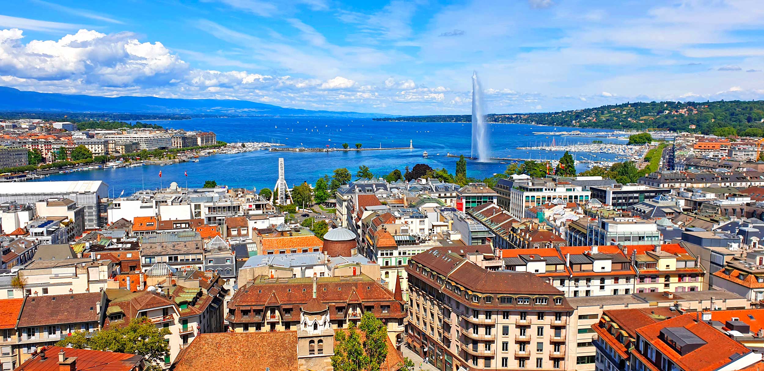 Aerial view of Geneva and Lake Geneva, home to TotalEnergies’ European hub as a leading energy trading firm.