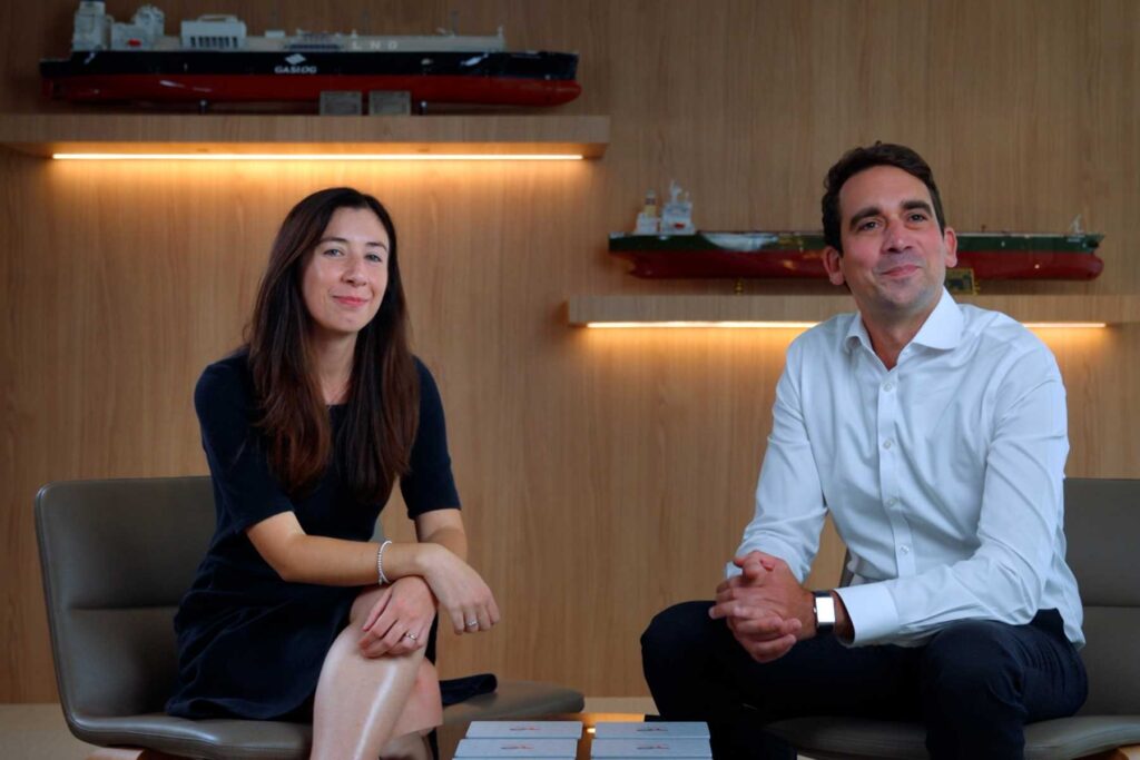 Power originator and energy trading professional discussing structured electricity market solutions in an office environment.